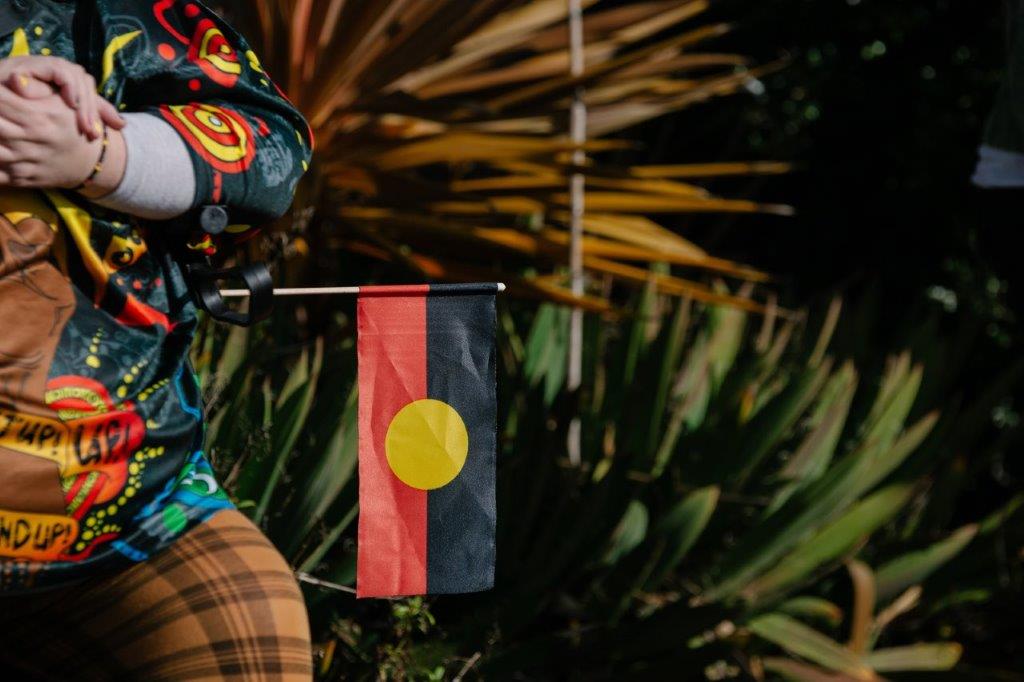 An Aboriginal flag hanging out of a persons pocket