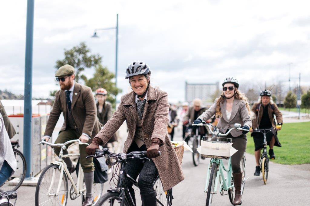 A group of people riding bicycles outside